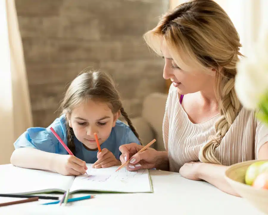 mother doing homework together with her daughter