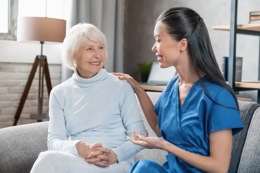 nurse assisting with elderly woman home